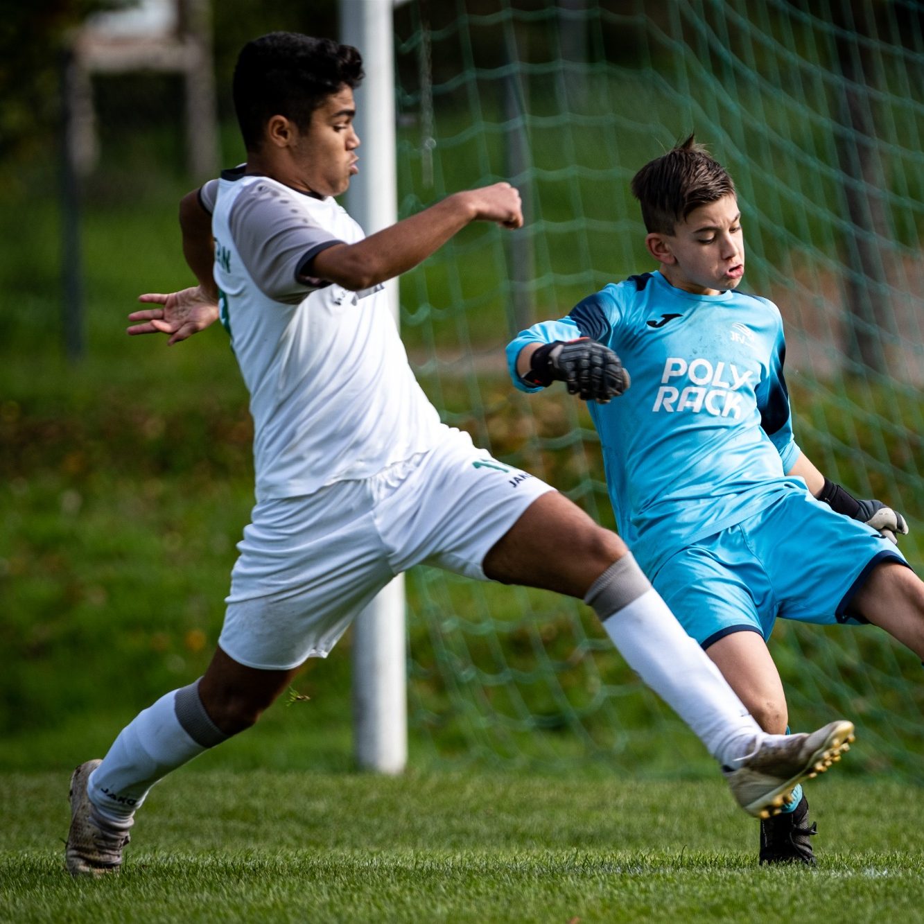 Ein Spieler in Fußballkleidung kickt den Ball während eines Spiels.